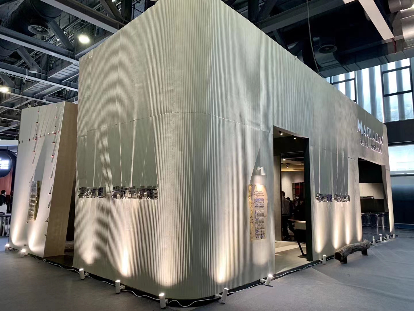 Client-supplied exhibition installation using a lined flexible-stone surface